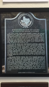Texas Historical Commission marker sits at the entrance of Muny on Enfield Road. 