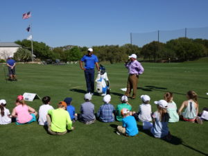 Johnathan Vegas (l) and Dale Morgan give a clinic to young golfers